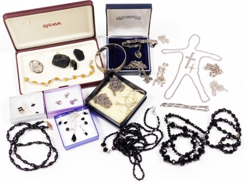 A group of silver and jet style jewellery, to include necklace and earring set, silver chains, bangle, modern imitation amber bracelet, brooch, etc. (1 tray)