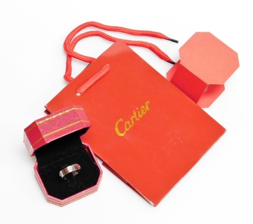 A Cartier style 18ct white gold love ring, with internal stamp serial number FN6389, ring size Q, 6g all in, with box and bag.