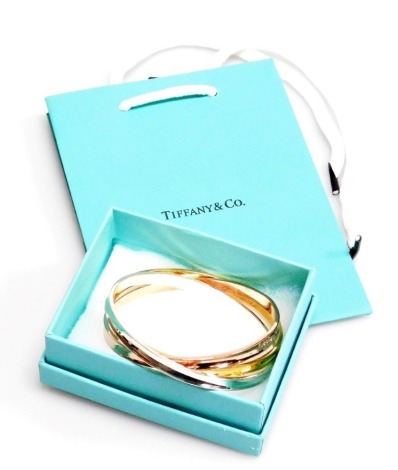 Three Tiffany and Co style bangles, of bi-colour design, white metal stamped 925, dated 1997, 7.5cm diameter, 53.4g all in, with box and bag.