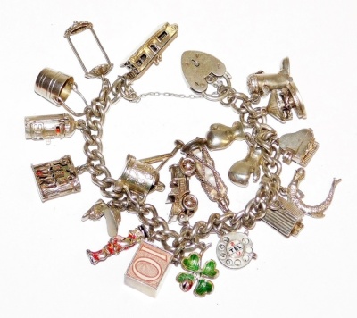 A silver charm bracelet, with various charms including car, house, boot, lantern, etc., on silver curb link bracelet, some charms marked silver, with a heart shaped padlock, 83.2g all in.