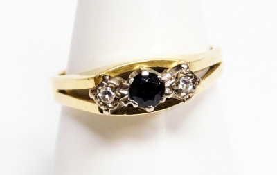 An 18ct gold sapphire and diamond dress ring, the central round brilliant cut sapphire in claw setting with two illusion set tiny diamonds, on pierced shoulders, ring size P½, 4.6g all in, boxed.