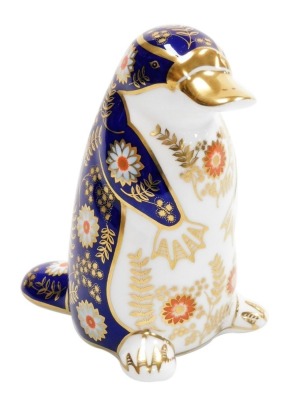 A Royal Crown Derby platypus porcelain paperweight, with silver stopper and red printed mark to underside, 12cm high, with associated boxed. Auctioneer Announce gold stopper