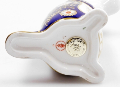 A Royal Crown Derby platypus porcelain paperweight, with silver stopper and red printed mark to underside, 12cm high, with associated boxed. Auctioneer Announce gold stopper - 3