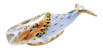 A Royal Crown Derby Guild Exclusive Oceanic Whale porcelain paperweight, with gold stopper and red printed mark to underside, 22cm wide, boxed.