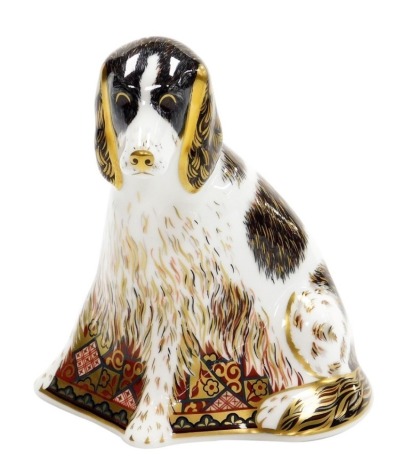 A Royal Crown Derby 'Molly' dog porcelain paperweight, exclusive for the Royal Crown Derby Collectors Guild, with gold stopper and red printed marks to underside, 12cm high, boxed.