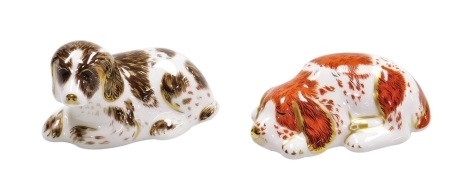 Two Royal Crown Derby porcelain paperweights, Scruff and Puppy, both for the Royal Crown Derby Collectors Guild, with gold stoppers and red printed marks to underside, 9cm wide and 9.5cm wide respectively.