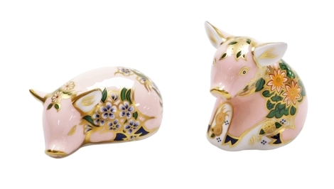 Two Royal Crown Derby piglet porcelain paperweights, comprising Plumstead Piglet and Pickworth Piglet, both commissioned for Sinclairs, with gold stoppers and printed marks beneath, 9cm wide and 5.5cm wide, both boxed with certificates.