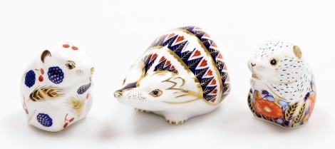 Three Royal Crown Derby porcelain paperweights, to include hedgehog, with gold stopper and red printed marks to underside, 12cm wide, harvest mouse, with gold stopper, 6.5cm wide, and Poppy Mouse, Collectors Guild exclusive, with gold stopper and red prin