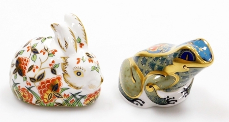 Two Royal Crown Derby porcelain paperweights, Fountain Frog, with gold stopper and red printed marks to underside, 9cm wide, and Meadow Rabbit, and exclusive for the Royal Crown Derby Collectors Guild, with gold stopper and red printed marks to underside,