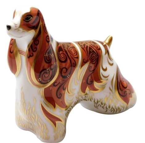 A Royal Crown Derby American Spaniel porcelain paperweight, with gold stopper and red printed marks to underside, 11cm high, boxed.