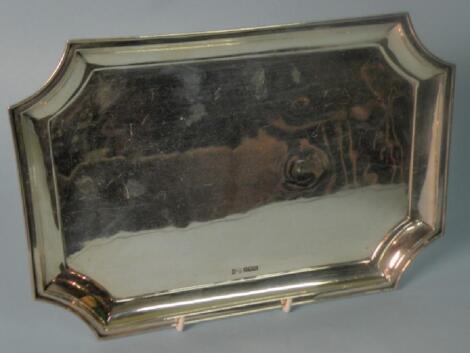 A canted rectangular silver tray with a raised border