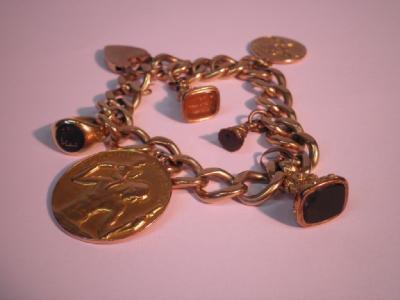 A heavy curb link bracelet with attached charms