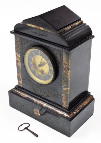 A Victorian slate and marble mantel clock, with a brass circular dial and black chapter ring bearing Roman numerals, thirty hour movement, the case of architectural form, with key, 31cm high, 23cm wide, 14cm deep.