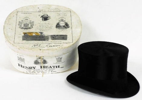 An early 20thC Henry Heath Ltd silk top hat, in original box, inside circumference approximately 54cm.