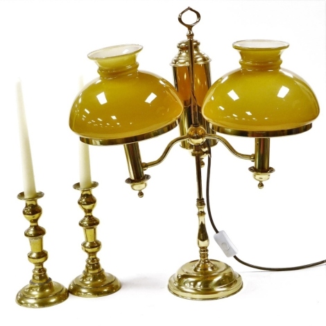 A collection of brassware, comprising a pair of Victorian candlesticks, 20cm high, and a two branch table lamp, with coloured glass shades, 52cm high.