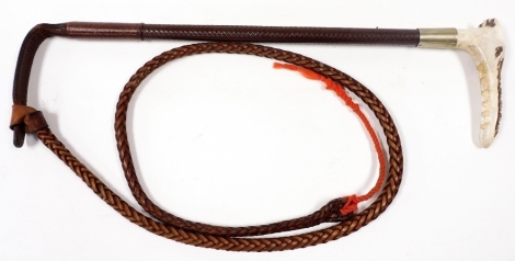 A 20thC ladies leather riding whip, with a simulated antler handle.