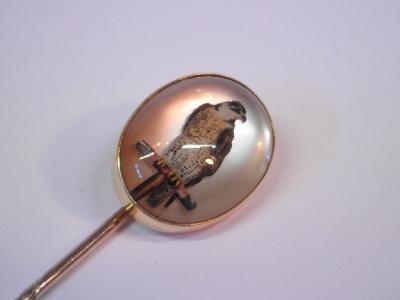 An Essex crystal of a Peregrine falcon set in a frame and pin stamped 18