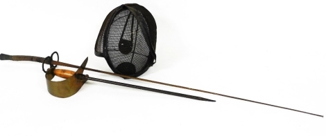 A vintage fencing mask and two associated fencing swords, one with turned handle, the other with a plain handle and heavy guard of shortened form, 50cm high. (a quantity)