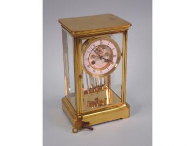 A late 19thC brass four glass mantel clock