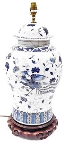 A Chinese porcelain vase and cover, converted to a table lamp, of baluster form, decorated in blue enamels with flowers and birds, 61cm high overall. (AF)