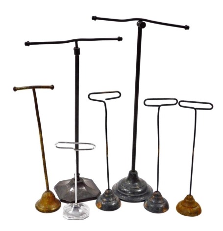 A group of early 20thC adjustable shop stands of various types, the largest 36cm high.