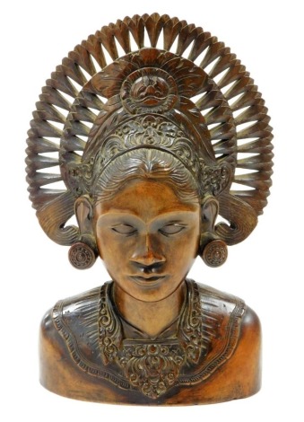 A Balinese carved wooden bust, of a lady wearing a pierced elaborate headdress, 27cm high.