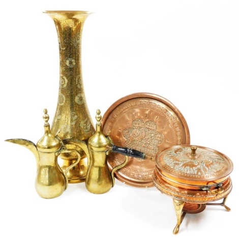 A quantity of metalware, comprising a large engraved brass vase, 60cm high, an Eastern embossed copper pan and stand, two Middle Eastern coffee pots, etc.