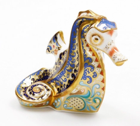 A Royal Crown Derby Coral Seahorse porcelain paperweight, an Exclusive Commission with limited availability to June 2004, with gold stopper and red printed marks to underside, 10cm high, boxed with certificate.