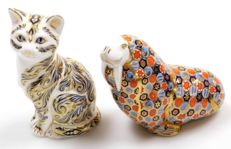 Two Royal Crown Derby porcelain paperweights, Majestic Cat, 13cm high, limited edition number 347/3500, with gold stopper and red printed mark to underside, and walrus, with gold stopper and red printed marks to underside, 13cm high, both boxed.