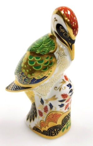 A Royal Crown Derby Newstead Woodpecker porcelain paperweight, designed by Jane James, with gold stopper and gold printed marks to underside, 17cm high, boxed with certificate.