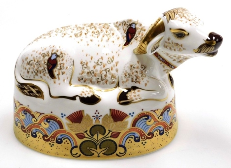 A Royal Crown Derby Water Buffalo porcelain paperweight, with gold stopper and red printed marks to underside, 18cm wide, boxed. (AF)