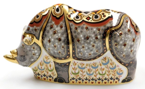 A Royal Crown Derby Black Rhino porcelain paperweight, designed by John Ablitt, limited edition number 23/500, with gold stopper and red printed marks to underside, 22cm wide, boxed with certificate.