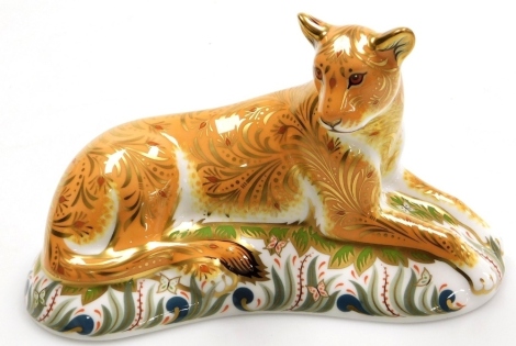 A Royal Crown Derby Lioness porcelain paperweight, commission by Goviers of Sidmouth, designed by Carmen Roome, with gold stopper and gold printed marks to underside, 19cm wide, boxed with certificate.