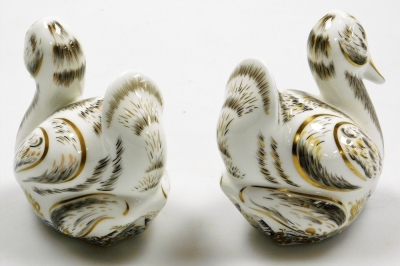 Two Royal Crown Derby Royal Cygnet porcelain paperweights, Royal Cygnet George and Royal Cygnet Charlotte, limited edition numbers 243/750, with gold stoppers and grey printed marks to underside, 10cm high, boxed. - 2