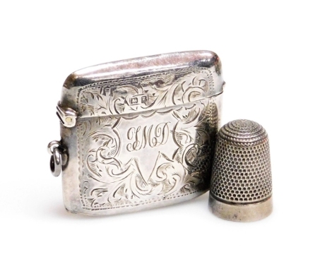 A George V silver Vesta case, with a monogrammed cartouche, engraved with foliate scrolls, Birmingham 1924, and a silver thimble. (2)