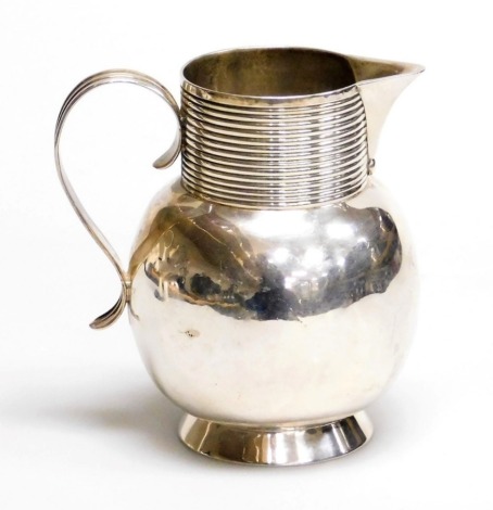 A George II silver jug, with a globular shaped body, fluted neck and sparrow beak, possibly Thomas Mason, London 1728, 7oz, 11cm high.