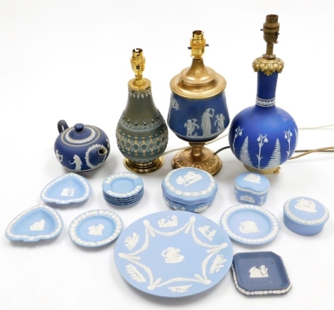 A group of Jasperware items, to include a late 19th/early 20thC table lamp, on a khaki green ground, with raised decoration, 33cm high overall, various Wedgwood Blue Jasperware trinket dishes, jars and covers, a Tunstall Dark Blue Jasperware teapot (spout