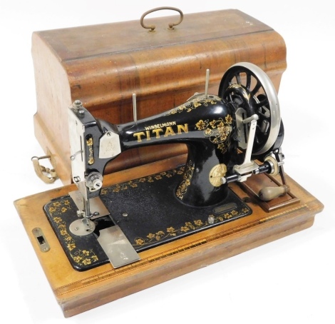 An early 20thC Winselmann Titan cased sewing machine, serial number 251456.