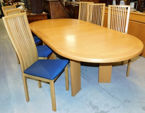 A Skovby Danish light oak dining table, with an oval top, the top 207cm x 105cm, and a set of six associated oak dining chairs with drop in seats.