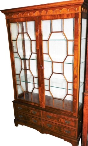 A 20thC Gostington's of Liverpool mahogany and cross banded display cabinet, the top with a moulded pediment, above a pair of astragal glazed doors, enclosing three glass shelves, with four drawers to the base, raised on bracket feet, 169cm high, 105cm w