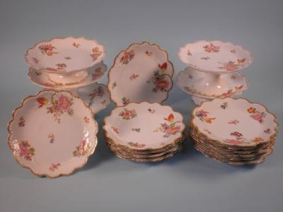 A Limoges porcelain dessert service comprising six comports and eleven plates