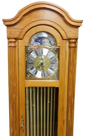 A Timecraft light oak longcase clock, with an arched moon phase dial, decorated with cherubic spandrels, silvered chapter ring bearing Roman numerals, subsidiary seconds dial, eight day three train movement with Westminster chimes, rod strike, the oak cas