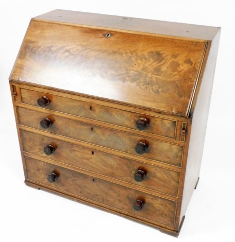 An early 19thC mahogany bureau, the fall enclosing a fitted interior, centred by cupboard and open shelves flanked by drawers, above four long drawers, 103cm high, 97cm wide, 58cm deep.