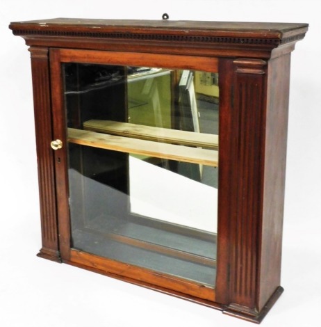 An early 20thC mahogany hanging cabinet, with glazed door flanked by reeded columns, with a glazed back on a compressed inverted base, 71cm high, 73cm wide, 22cm deep.