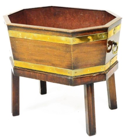 A 19thC mahogany and brass bound octagonal wine cooler, with plain interior, on canted legs, 50cm high, 53cm wide, 38cm deep.