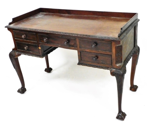 An early 20thC Chippendale style mahogany dressing table, with three part galleried back, with a heavily carved acanthus leaf outline, raised above five frieze drawers, on cabriole legs terminating in claw and ball feet, 86cm high, 115cm wide, 52cm deep.