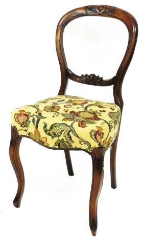 A Victorian balloon back chair, with carved back and overstuffed seat, on sabre front legs, 88cm high.