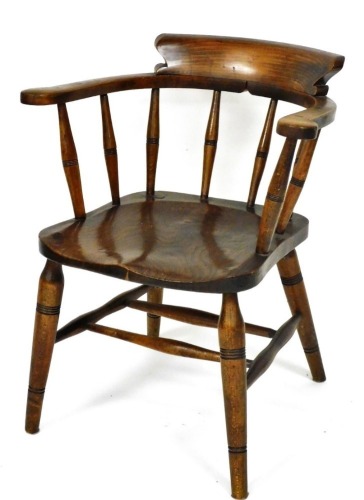 A Victorian beech and elm smoker's bow chair, with a spindle back, solid seat, raised on turned legs united by a double H frame stretcher, 75cm high.