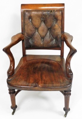 A 19thC mahogany smoker's chair, with a brown leather button back, solid seat, raised on turned legs, brass capped on castors. - 2