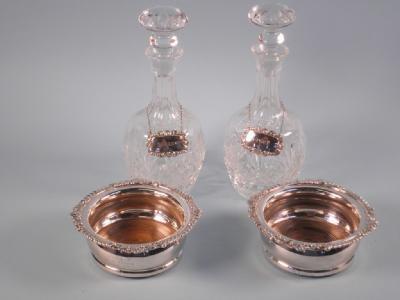 A pair of silver plated coasters
